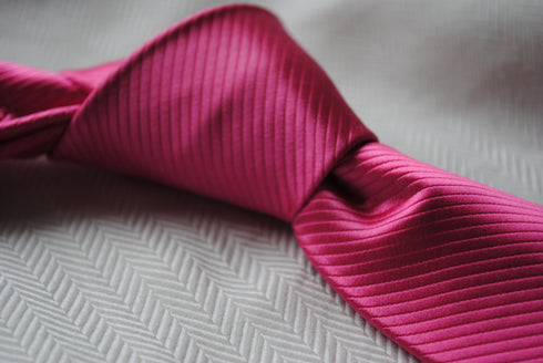 bright pink tie with a very subtle stripe