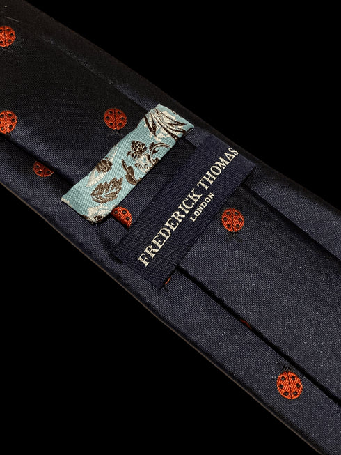 navy tie with embroidered ladybird design