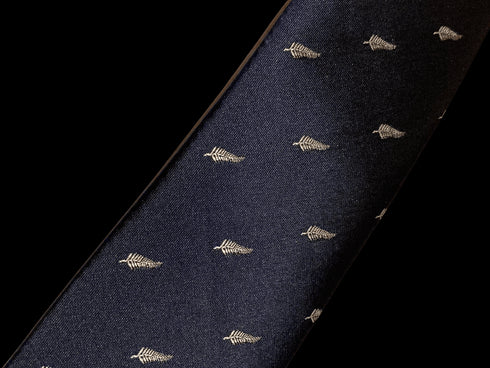 navy tie with embroidered New Zealand feather silver fern design