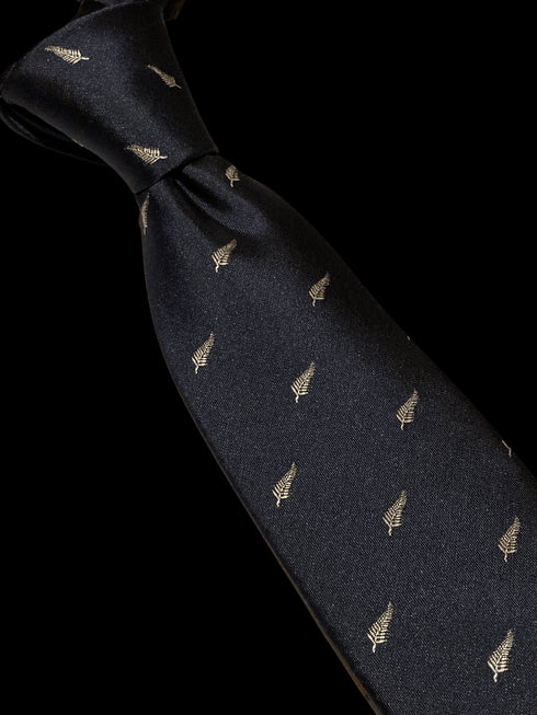 navy tie with embroidered New Zealand feather silver fern design
