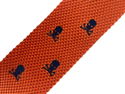 orange knitted tie with embroidered navy skull and crossbone design