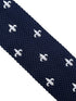 navy blue knitted tie with white embroidered fleur de lis lys design