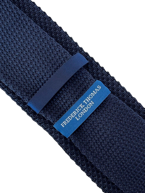 navy blue knitted tie with white embroidered fleur de lis lys design