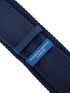 navy blue knitted tie with white embroidered fleur de lis lys design