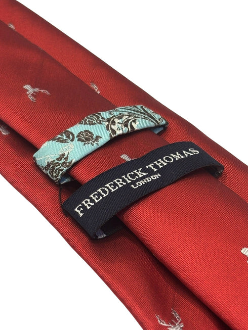 dark red tie with an embroidered deer head design