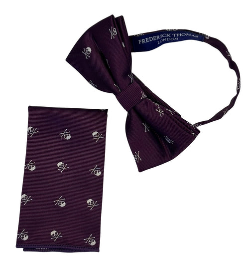 matching purple bow tie and pocket square with white skull and crossbone design