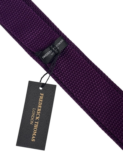 purple knitted tie with white polka spot design