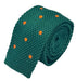 knitted tie in emerald green with an orange polka spots design