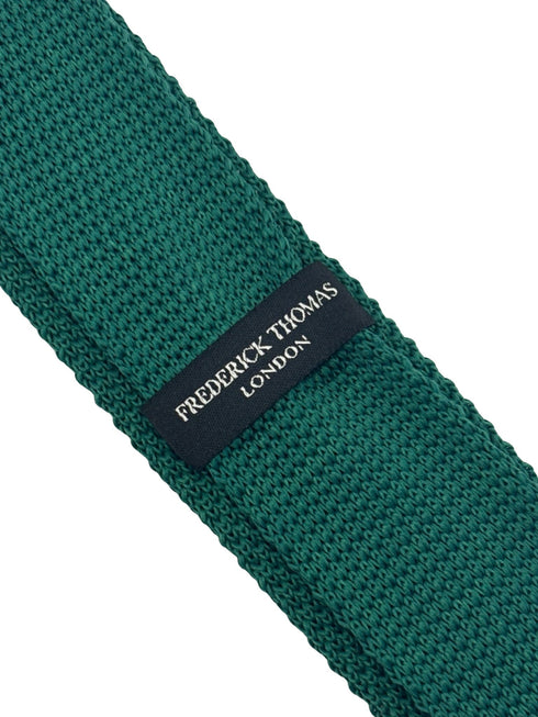 knitted tie in emerald green with an orange polka spots design