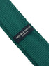 knitted tie in emerald green with an orange polka spots design
