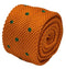 knitted tie in bright orange with emerald green polka dots