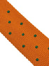 knitted tie in bright orange with emerald green polka dots