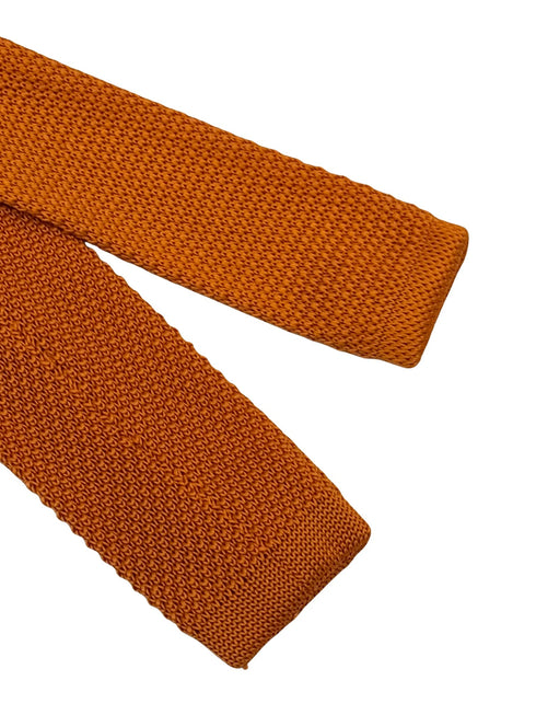 knitted tie in bright orange with emerald green polka dots