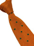knitted tie in bright orange with emerald green polka dots