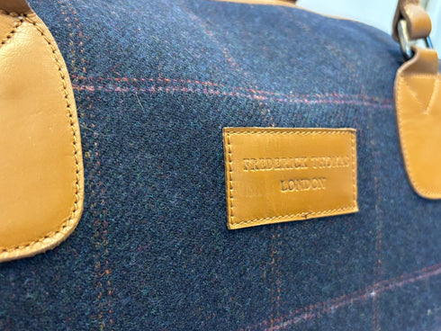 Luxury weekend overnight bag in navy blue check with tan leather handles