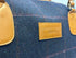 Luxury weekend overnight bag in navy blue check with tan leather handles