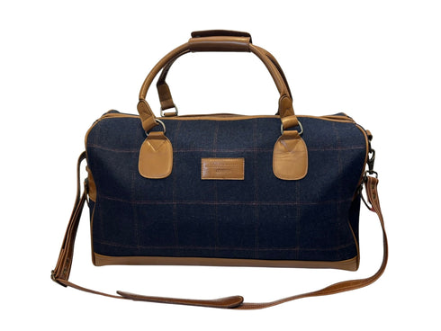 Luxury weekend overnight bag in navy blue check with tan leather handles