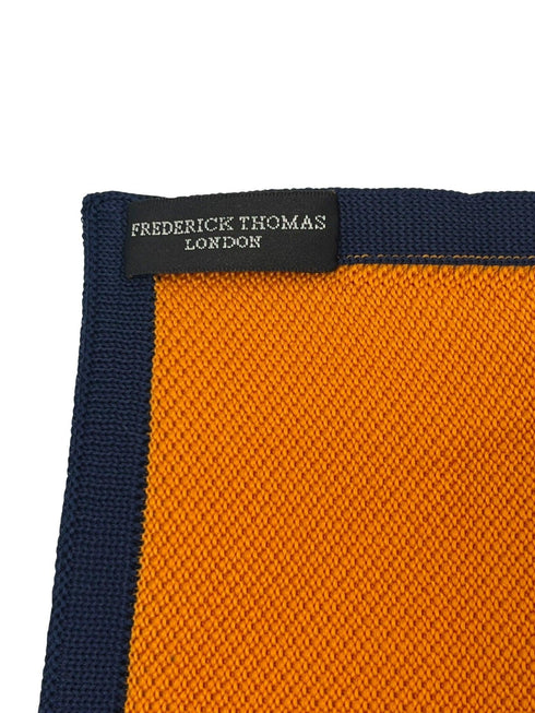 orange knitted pocket square with navy dark blue edging