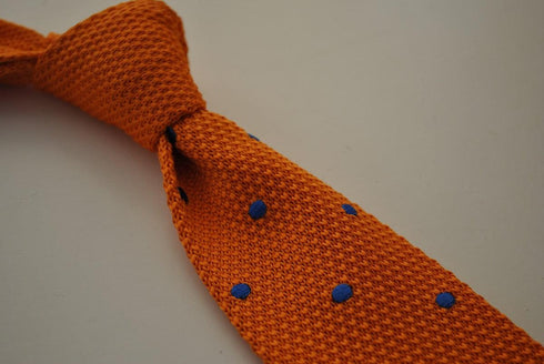 knitted orange tie with royal blue polka dots