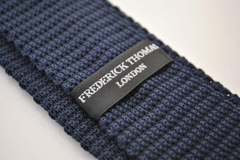 navy blue skinny knitted tie with gold polka dots