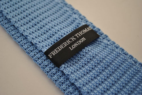 light blue skinny knitted tie with dark blue polka dots