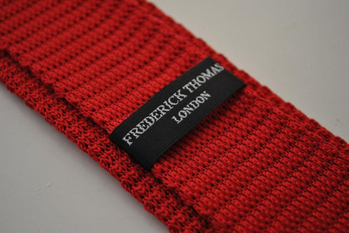 red skinny knitted tie with white polka dots