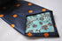 navy tie with orange polka spots