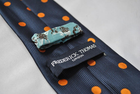 navy tie with orange polka spots