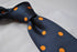 navy tie with orange polka spots