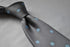 grey tie with light blue polka spot