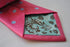 bright pink tie with light blue polka dots