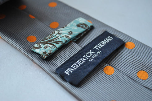 grey tie with orange polka dots