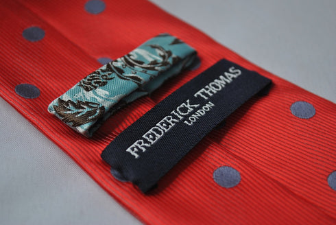 red tie with grey polka dots