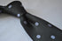 black tie with grey polka dots