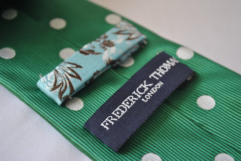 dark green tie with white polka dots