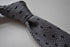 grey skinny knitted tie with black polka dots