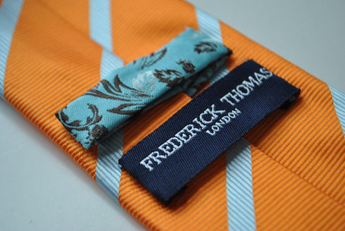 orange tie with light blue club stripes