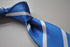 blue tie with white club stripes