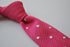bright pink skinny knitted tie with white polka dots