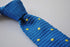 royal blue skinny knitted tie with yellow polka dots