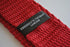 red skinny knitted tie with white tip