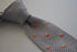 grey skinny knitted tie with orange polka dots