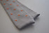 grey skinny knitted tie with orange polka dots