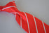 red tie with thin white stripes