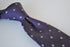purple tie with fleur de lis pattern
