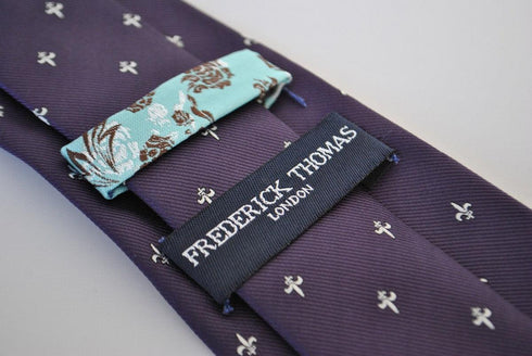 purple tie with fleur de lis pattern