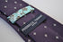 purple tie with fleur de lis pattern