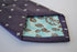 purple tie with fleur de lis pattern