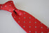 red tie with fleur de lis pattern