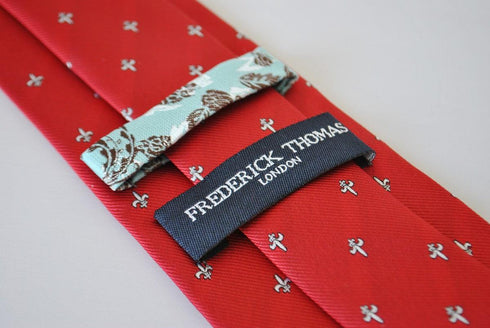 red tie with fleur de lis pattern